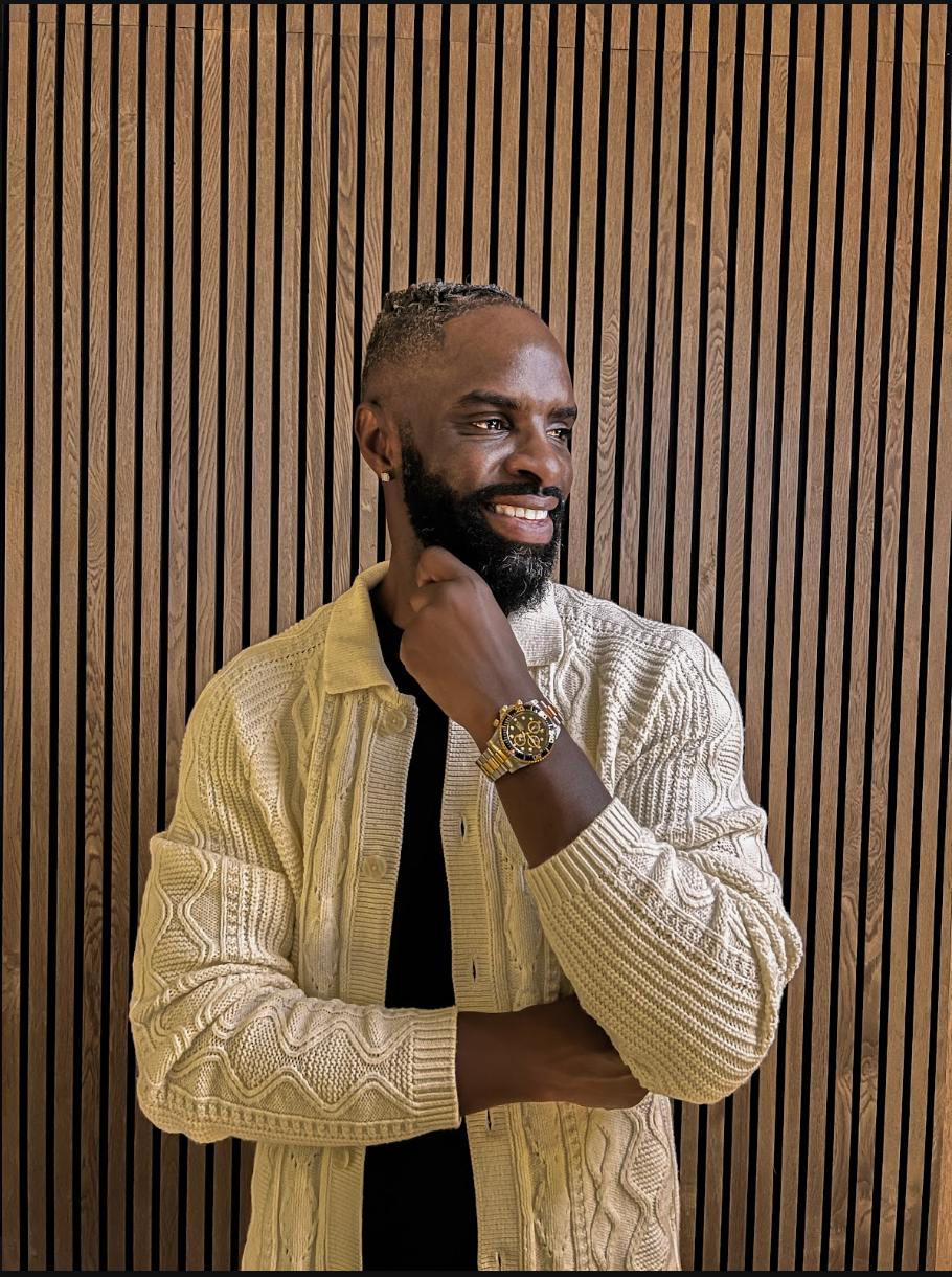 Ron Harness smiling in his cream cardigan, from the original founder brand shoot