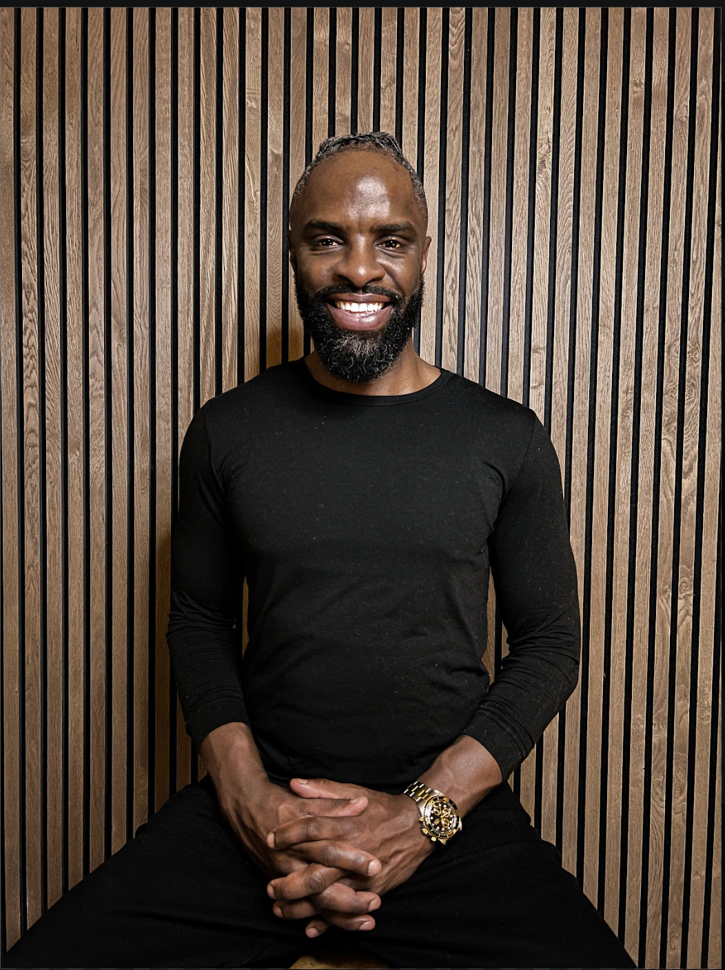 Ron’s smiling founder portrait in a black shirt